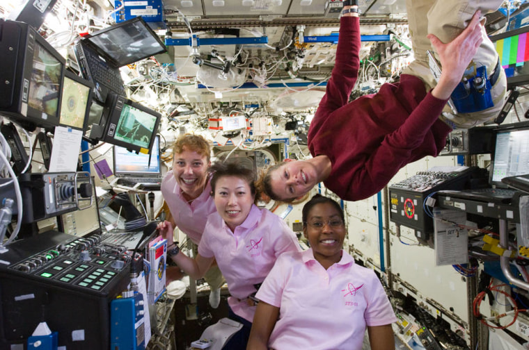In this April 8, 2010 photograph, STS­131 mission specialists Stephanie Wilson of NASA, Naoko Yamazaki of the Japanese Aerospace Exploration Agency (JAXA), Dorothy Metcalf­Lindenburger of NASA, and Expedition 23 flight engineer Tracy Caldwell Dyson (top left) work at the robotics workstation on the International Space Station, in support of transfer operations using the station's Canadarm2 robotic arm to move cargo from the Multi­Purpose Logistics Module.