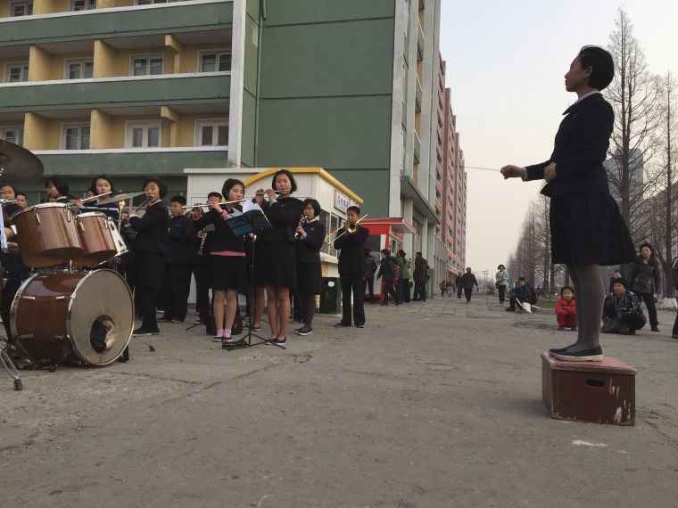 Image: Schoolchildren play music to entertain and inspire people on their way home from work