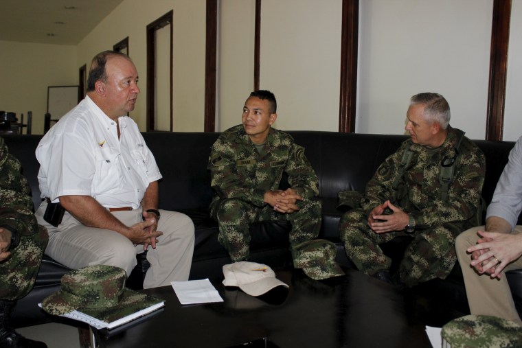 Colombian Defense Minister Luis Carlos Villegas talks with Army Corporal Jair de Jesus Villar, after he was freed by the National Liberation Army, or ELN, in Barrancabermeja