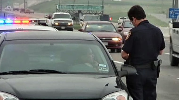 Police officer writing a ticket for a traffic violation.