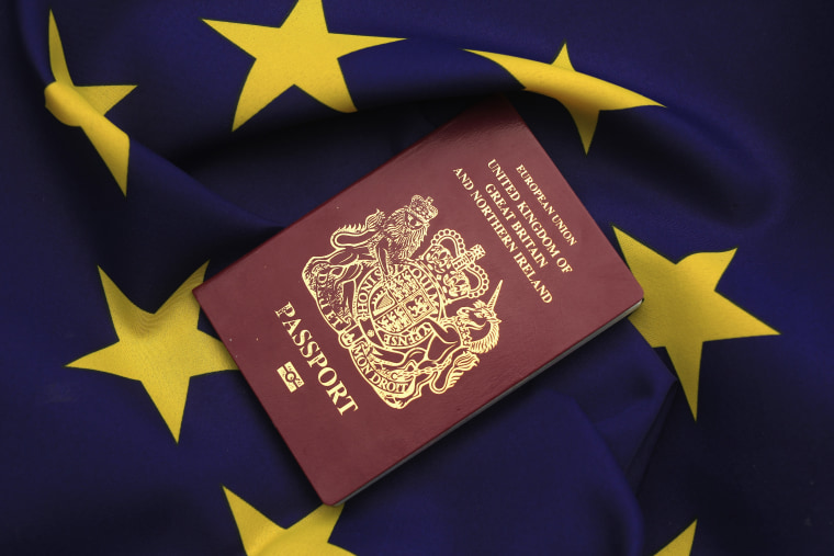 Image: United Kingdom passport sits on EU flag