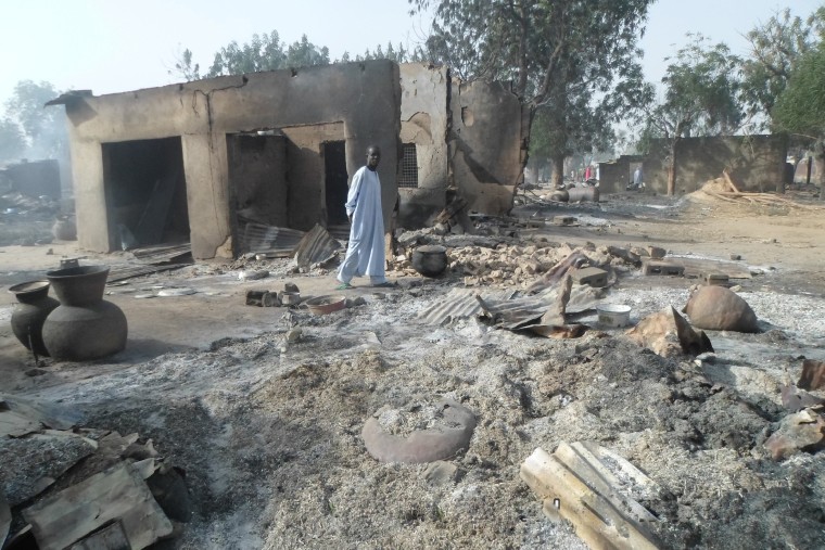 A man walks past burnt out houses following an attack by Boko Haram in Dalori village near Maiduguri, Nigeria on in January 2016.