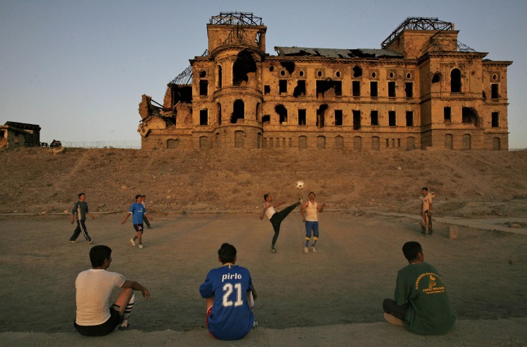 Image: Afghan men play soccer in front of the bombed out old royal palace, in Kabul, Afghanistan, Wednesday, Sept. 23, 2009. The palace was designed by a French architect and originally built in 1923 by King Amanullah.
