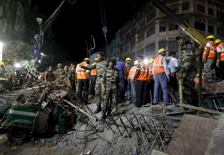 Image: Firefighters and rescue workers search for victims at the site of an under-construction flyover after it collapsed in Kolkata
