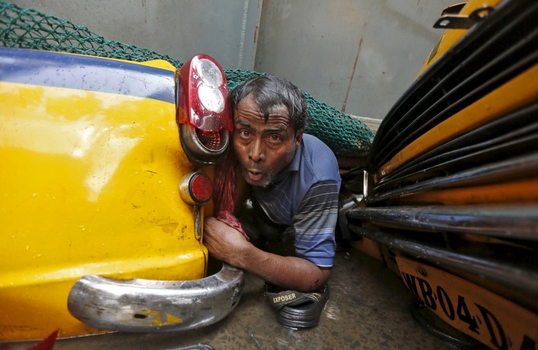 Image: A man is seen trapped amid the debris of an under-construction flyover after it collapsed in Kolkata