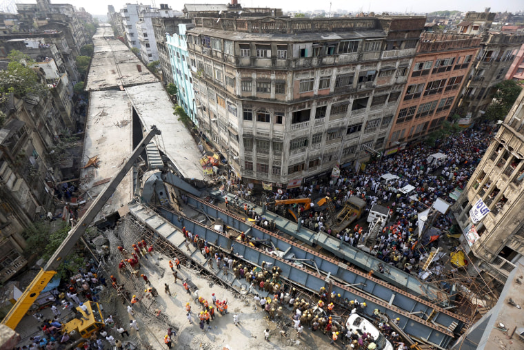 Image: Firefighters and rescue workers search for victims at the site of an under-construction flyover after it collapsed in Kolkata