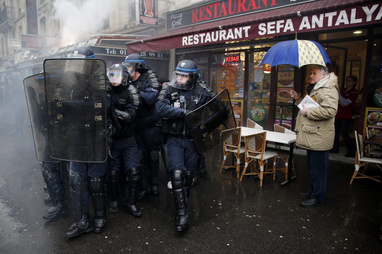 Image: French police clash with demonstrators during a protest against the labor law reform bill in Paris
