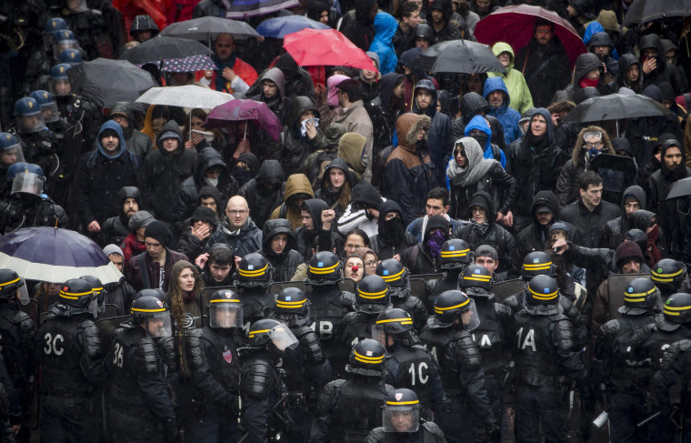 Image: French riot police hold back demonstrators as they try to march during a protest against the labor law reform bill