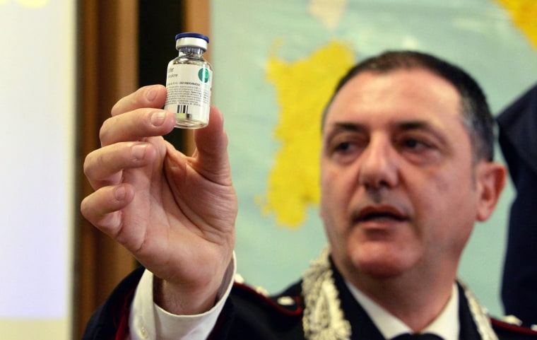 Image: Carabinieri captain Gennaro Riccardi shows a phial containing heparin during a new conference in Livorno, Italy, Thursday.