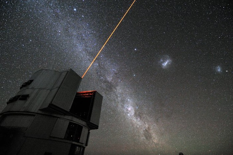 A new paper describes how laser beams could disrupt measurements of Earth's orbit around the sun, potentially deceiving inquisitive aliens. Here, a 22W laser used for adaptive optics shines from the Very Large Telescope in Chile. 