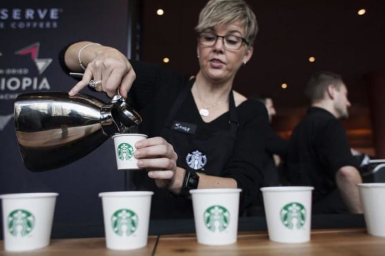 Barista Sandy Roberts pours samples of Starbucks coffee during the company's annual shareholders meeting in Seattle