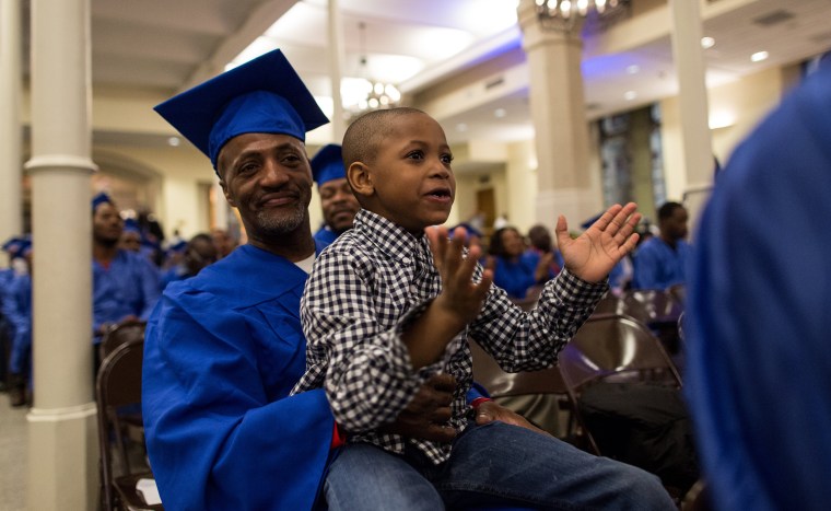 Image: Anthony Lewis, 52, of the Bronx, with his son Elias, 6, during the graduation from the year-long Ready, Willing &amp; Able transitional work program on March 31 at the Church of St. Ignatius Loyola on the Upper East Side of Manhattan.