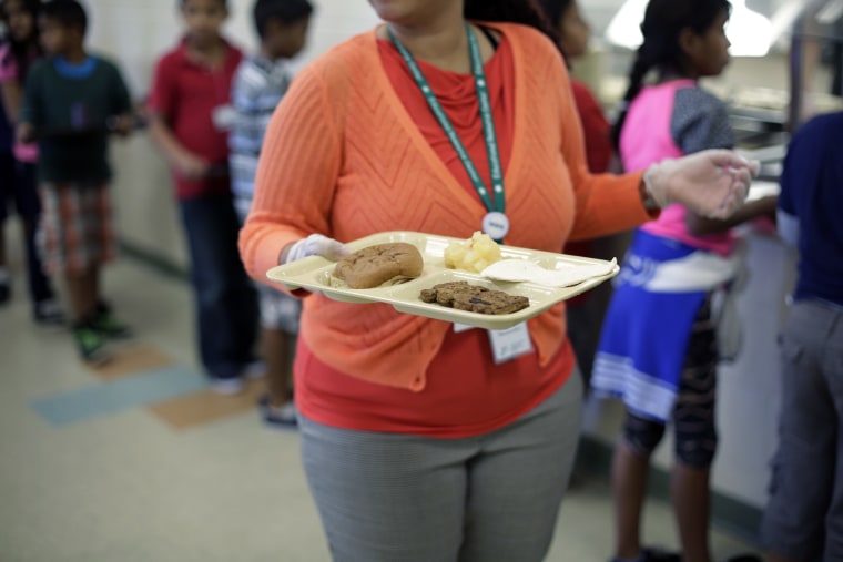 Detained immigrant children line up in the cafeteria at the  Karnes County Residential Center,  a temporary home for immigrant women and children detained at the border, on Sept. 10, 2014, in Karnes City, Texas.