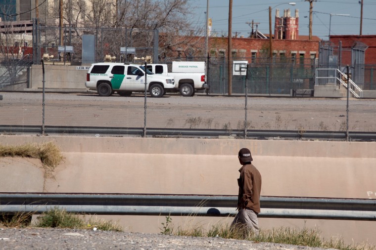 Image: A man looks at Border Patrol vehicles parked in El Paso, Texas, as seen from Ciudad Juarez