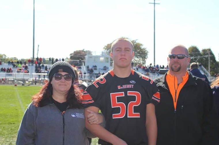 Zack Sielck before a football game with his foster parents, Brigid and Jason Sterwerf.