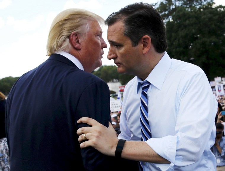 Image: File photo of U.S. Senator Cruz greeting Trump onstage as they address a Tea Party rally at the U.S. Capitol in Washington