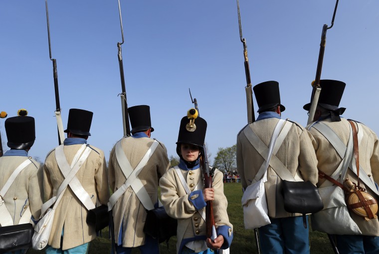 Image: People dressed as Austrian soldiers of the Habsburg dynasty take part in the re-enactment of the battle against Hungary in Tapiobicske