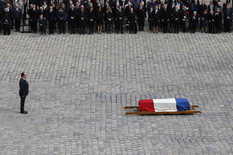 Image: Hollande stands near the flag-draped coffin of French writer and academic Alain Decaux