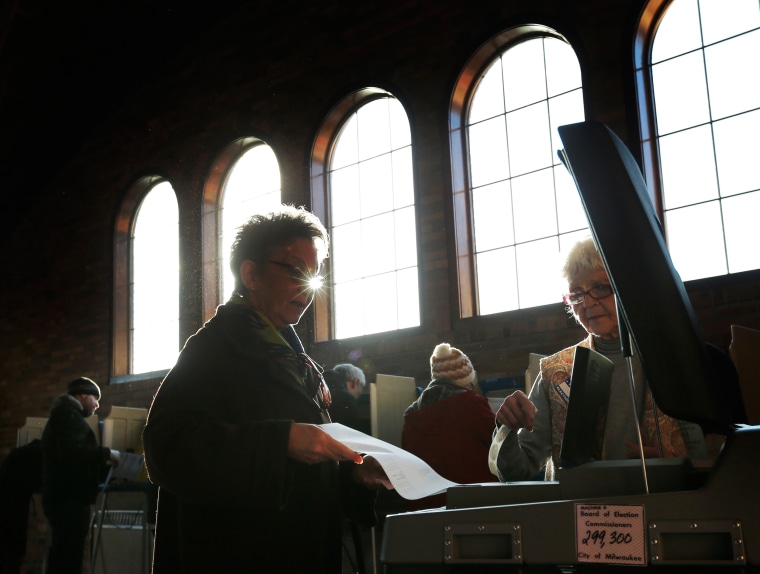 Image: A Wisconsin voter casts her ballot in the state's primary at the South Shore Park Pavilion in Milwaukee