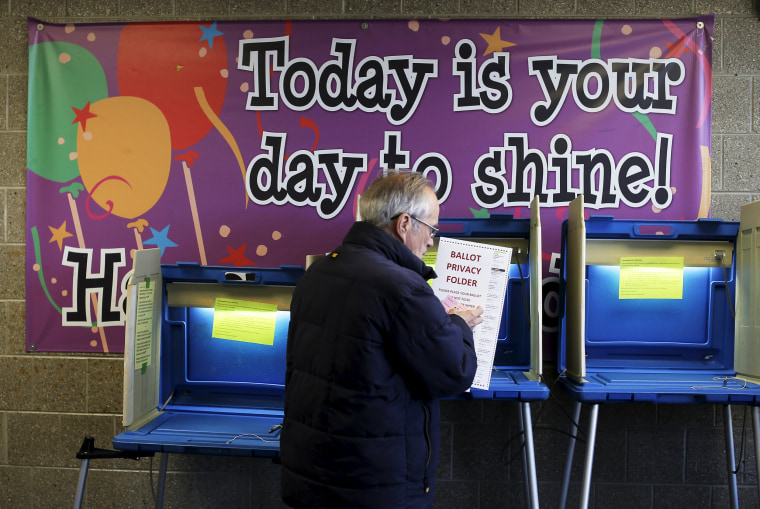 Image: A voter casts his ballot in the Wisconsin presidential primary election at a voting station in Milwaukee