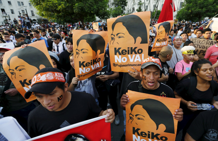 Image: Protesters holding signs attend a march against Peruvian presidential candidate Keiko Fujimori in downtown Lima