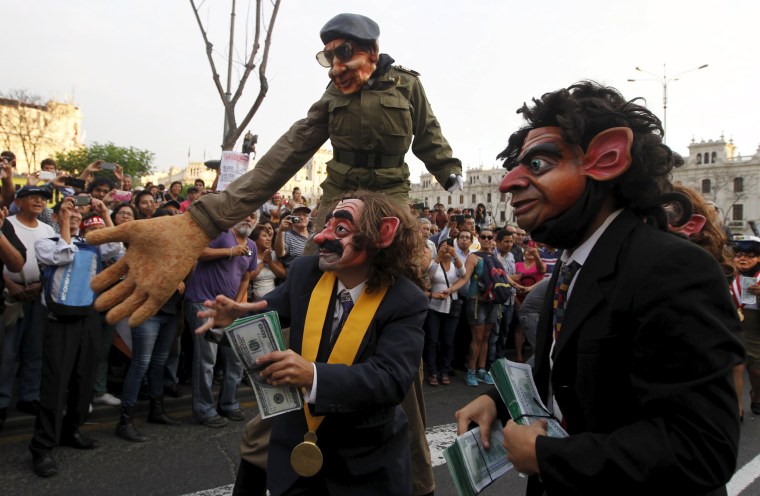Image: Protesters representing corruption perform during a march against Peruvian presidential candidate Keiko Fujimori in downtown Lima