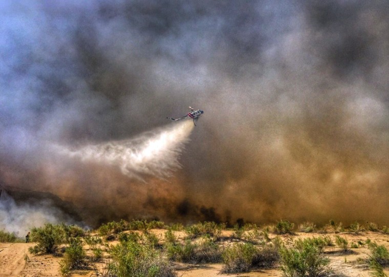 Image: A helicopter making a drop on a wildfire