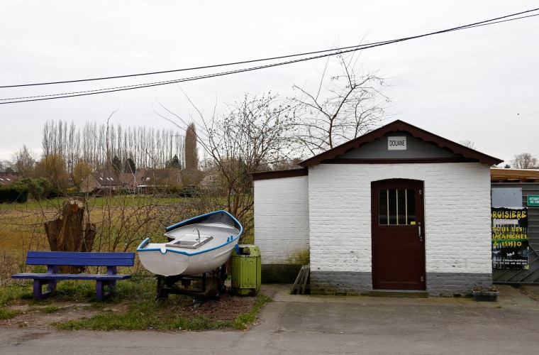 Image: A old customs post along a river at the border between Belgium and France in Leers-Nord