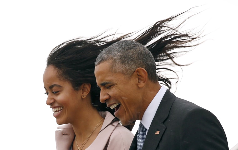 Image: Malia Obama's hair flies into the air as a cold wind hits her and U.S. President Barack Obama