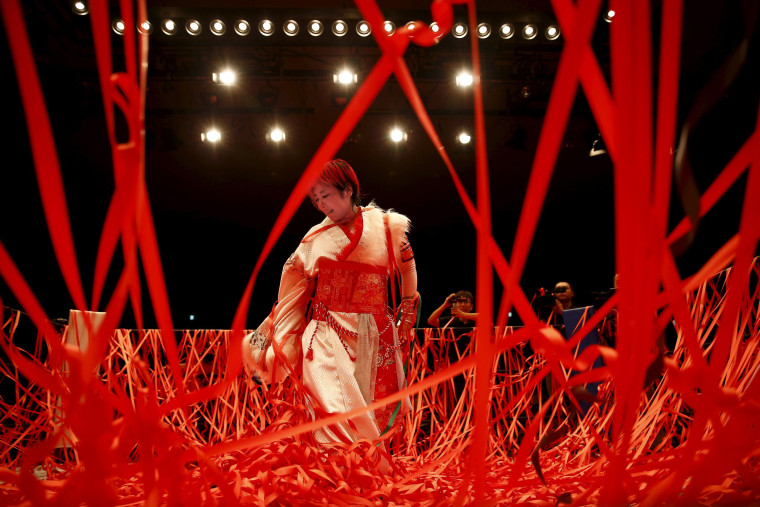 Image: Ticker tape confetti rains on wrestler Act Yasukawa after her last match before retirement
