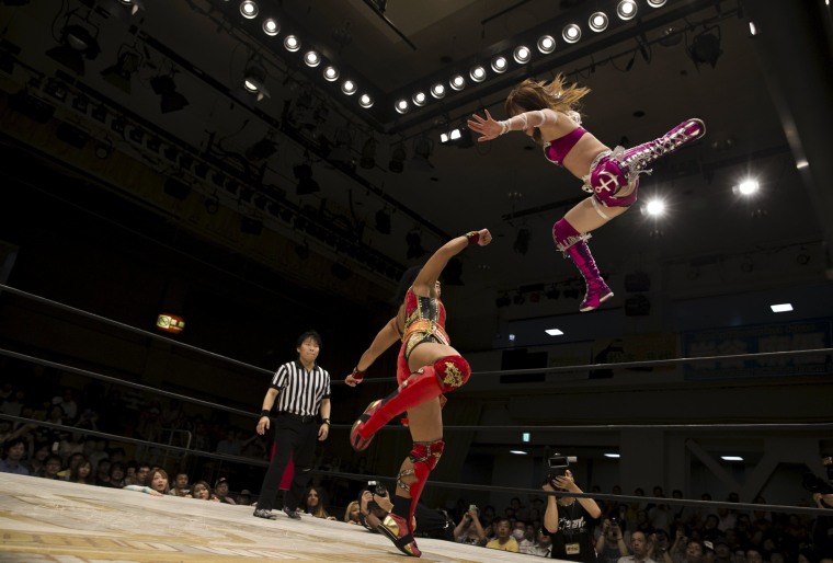 Image: Wrestler Kaori Housako jumps at her opponent Mieko Satomura