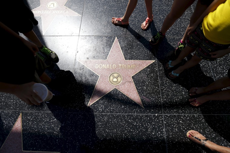 Image: People gather around the star of U.S. Republican presidential candidate Donald Trump on the Hollywood Walk of Fame in Hollywood