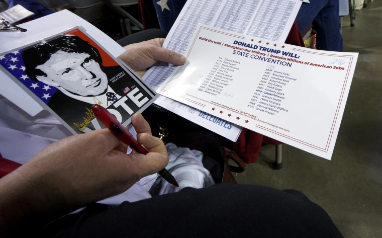 Image: A delegate supporting Republican U.S. presidential candidate Donald Trump looks over documents at the Colorado Republican state convention in Colorado Springs