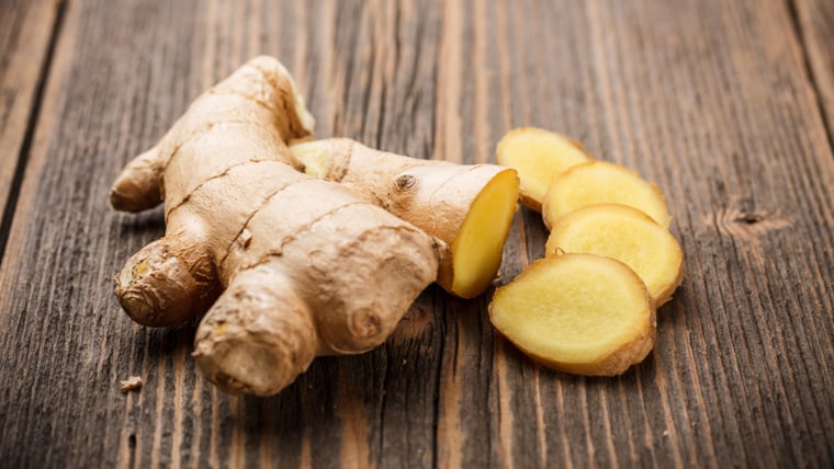 Ginger root sliced on wooden table