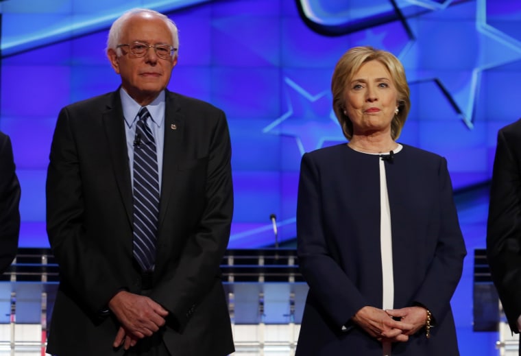 Image: Democratic presidential candidate Senator Bernie Sanders and former Secretary of State Hillary Clinton stand together before the start of the first official Democratic candidates debate of the 2016 presidential campaign in Las Vegas