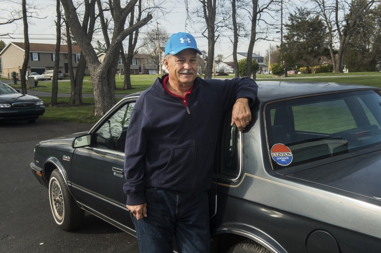 Mike Lawn stands next to a car formerly owned by Hillary Clinton in Gettysburg, Pa., on April 6. The retired White House gardener is selling Clinton's 1986 Oldsmobile Cutlass, which he bought at an auction for the residence's workers and has been sitting in his Pennsylvania garage for years.