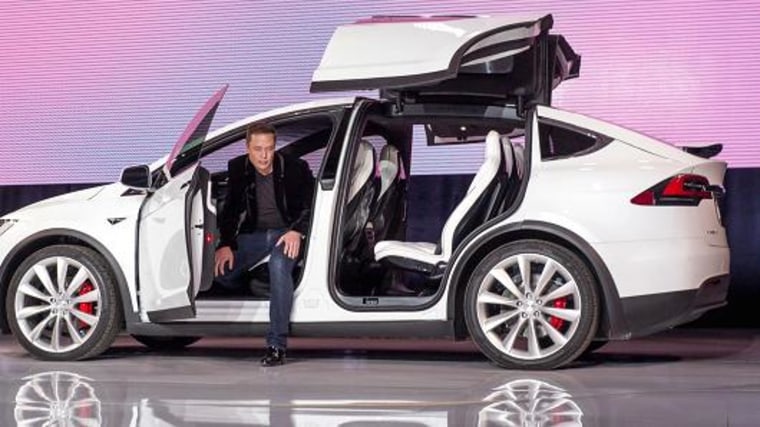 Elon Musk, chairman and chief executive officer of Tesla Motors Inc., exits the Model X sport utility vehicle (SUV) during an event in Fremont, California, U.S., on Tuesday, Sept. 29, 2015.