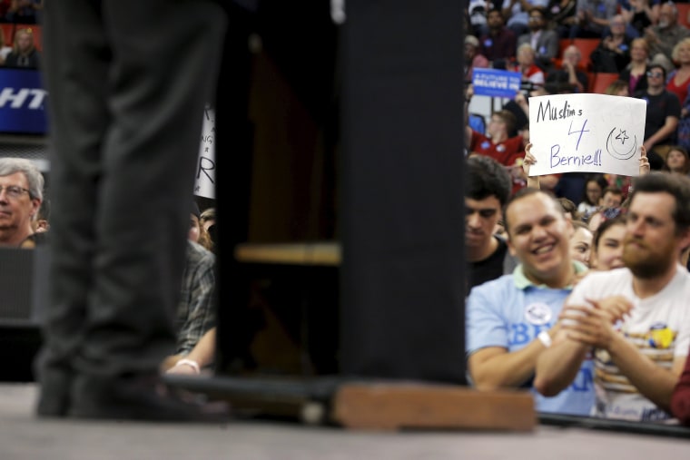 Image: An audience member holds a "Muslims 4 Bernie" sign at a campaign rally with U.S. Democratic presidential candidate and U.S. Senator Bernie Sanders in Oklahoma City