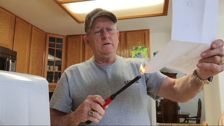 Image: Larry Wayne Lindsey burns his Colorado Republican party registration