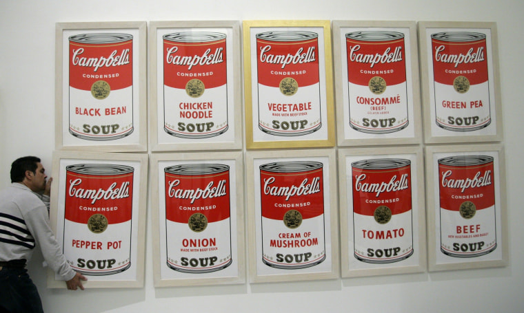 Image: File photo of a worker hanging a print by US artist Andy Warhol at Es Baluard museum in Palma de Mallorca