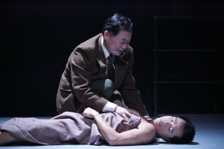 George Takei kneels over Trieu Tran in East West Player's 2005 production of "Equus."