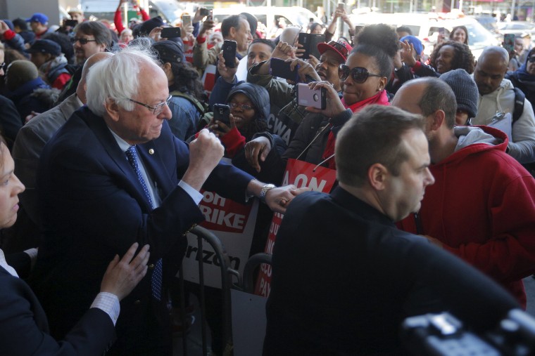Image: U.S. Democratic presidential candidate and U.S. Senator Bernie Sanders greets Communications Workers of America (CWA) workers striking against Verizon in Brooklyn
