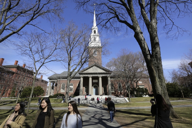 Image: People walk on the campus of Harvard University