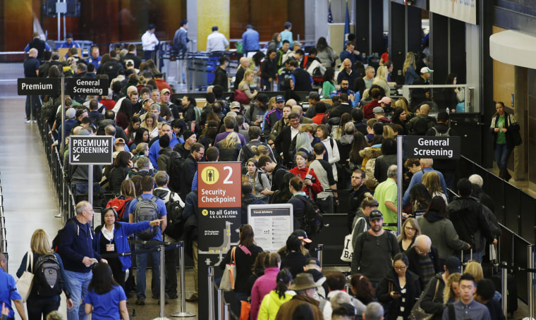 Image: Travelers wait in line for security screening at Seattle-Tacoma International Airport