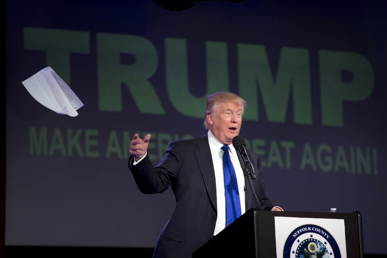 Image: Donald Trump tosses his notes as he speaks during a Suffolk County Republican Committee