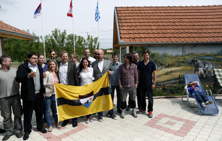 Vit Jedlicka, self-declared president of Liberland, fourth from left, poses with flag and supporters of the Liberland idea Serbia, on May 1, 2015.