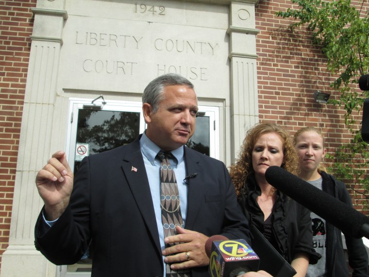 Suspended Liberty County Sheriff Nick Finch talks with reporters on the courthouse steps in Bristol, Fla., on Oct. 31, 2013 after his acquittal on charges of official misconduct and falsifying official records. Finch admitted freeing a concealed weapons suspect who had been frisked in a traffic stop, but said he did so because he believes the Second Amendment gives citizens a legal right to bear arms.