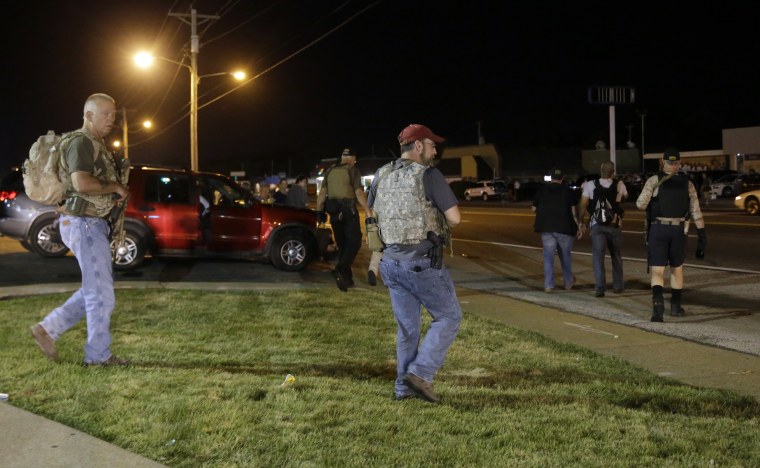 Heavily armed civilians with a group known as the Oath Keepers arrive in Ferguson, Mo., on Aug. 11, 2015.