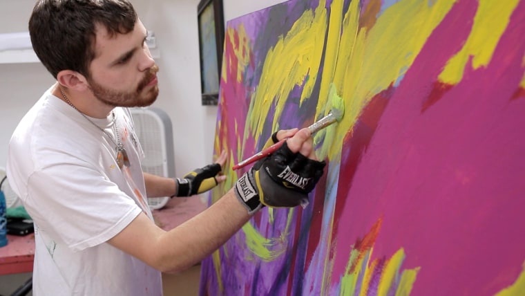 Image: Autistic artist Jeremy Sicile-Kira works on a painting at his San Diego studio.