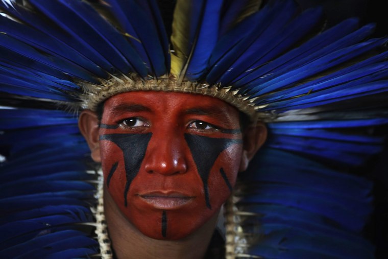 Image: A member of the indigenous Pataxo group participates in a demonstration